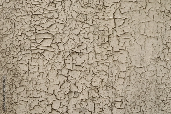 Fototapeta Textured surface with beige cracked paint
