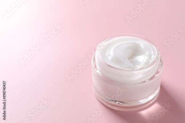 Fototapeta Face cream in jar on pink background, closeup. Space for text