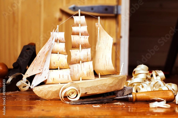 Obraz Wooden ship toy workshop carpenter with a plane, chips, birch