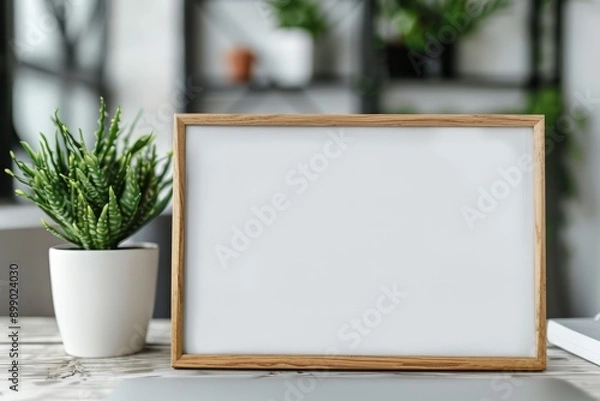 Fototapeta Stylish wooden frame with a blank canvas, perfect for decoration or personalization in modern home or office settings.