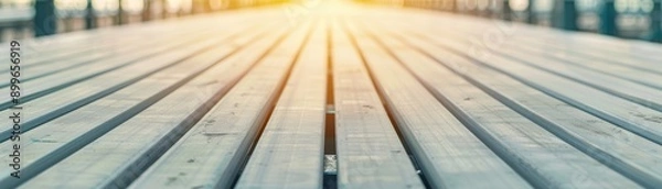 Obraz A serene view of wooden planks under soft sunlight, creating a warm and inviting atmosphere for various design projects.