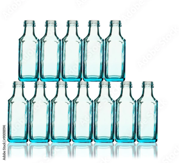 Fototapeta Stack of blue bottles back lit
