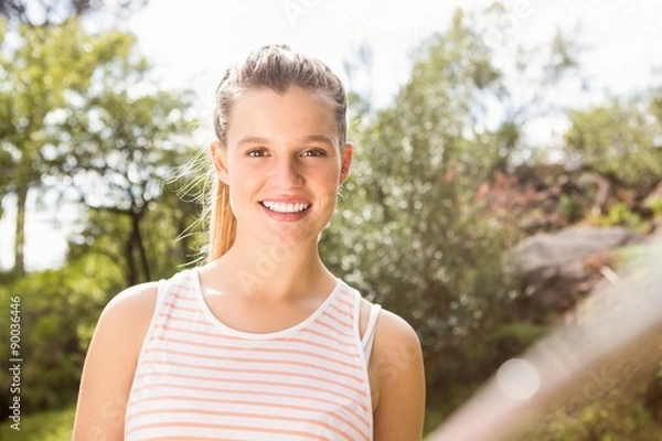 Fototapeta Smiling pretty blonde taking selfies with selfiestick
