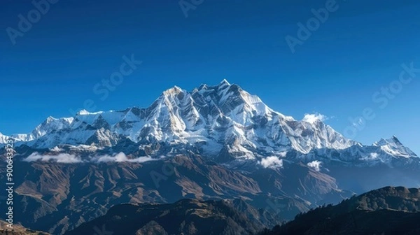 Fototapeta Scenic view of a snowy mountain range under a clear blue sky Nature
