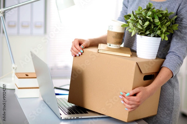 Obraz Happy team of businesspeople moving office, packing boxes