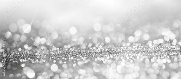 Fototapeta Defocused monochromatic light background with an abstract silver glitter backdrop perfect for a copy space image