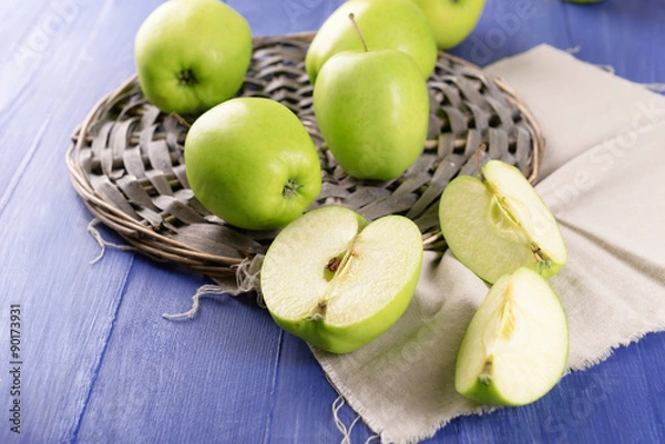 Fototapeta Sliced green apple on wooden table, closeup
