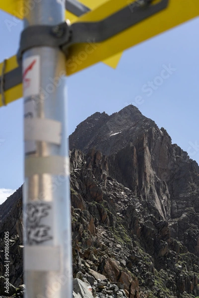 Fototapeta Hiking signpost with mountain peak in the background