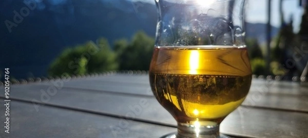 Fototapeta glass of whiskey in the afternoon sunshine on patio close up