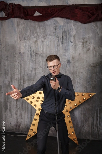 Obraz Young man singing with microphone