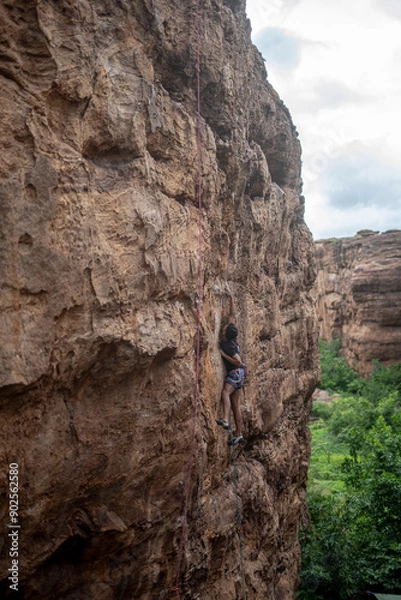 Obraz A climber trying to move on a climbing wall in Badami, Karnataka.
