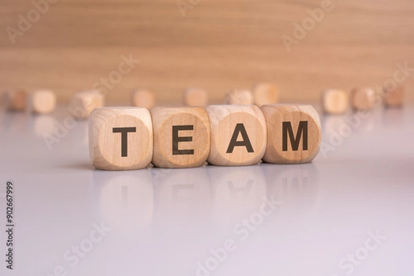 Obraz Team concept Illustrated with wooden blocks on a reflective surface for understanding collaboration