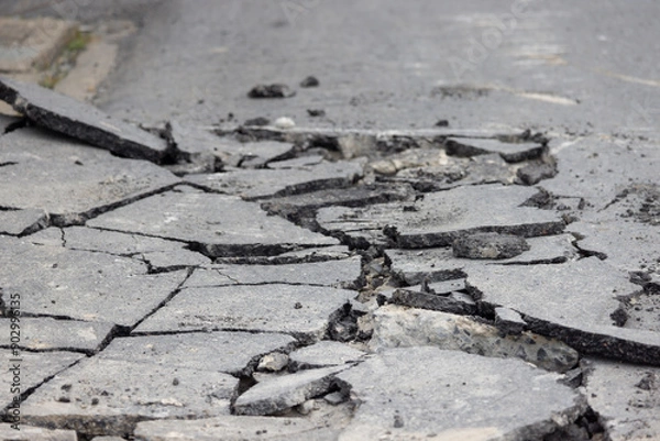 Obraz A cracked road with a lot of debris