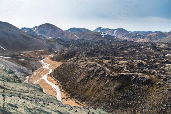 Fototapeta Hiking up the sulphur peak with views of old lava remains and river meandering through in Landmannalaugar in Iceland