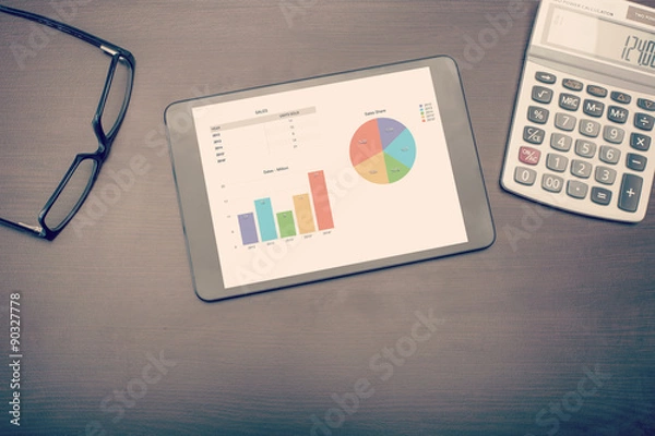 Fototapeta A tablet device showing statistics