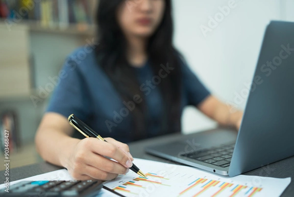 Fototapeta Woman working on desk with using calculator, finance accounting.
