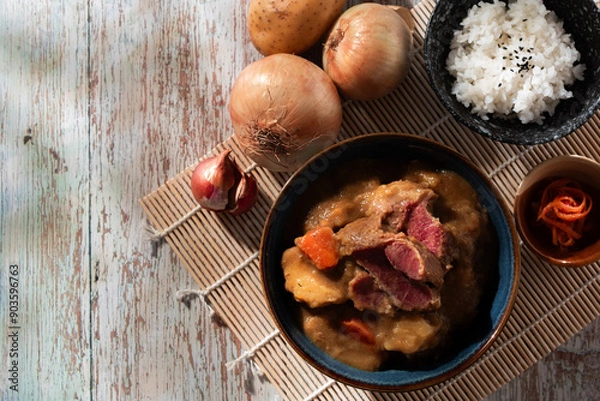 Fototapeta Japanese beef curry on a rustic  wooden background.
