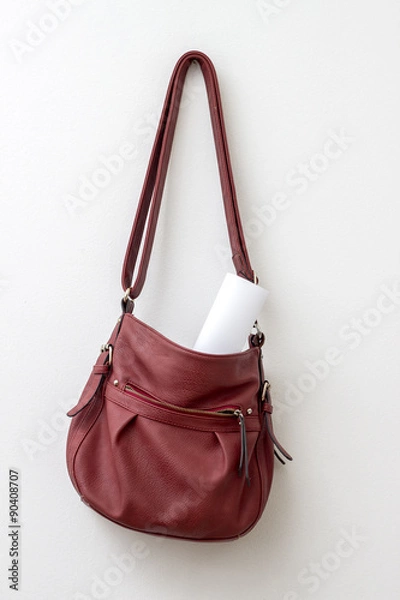 Obraz Red bag hanging  over a white wall
