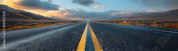 Fototapeta Open road at sunset with dramatic clouds, perfect for travel and adventure themes. Captures both serenity and the promise of new horizons.