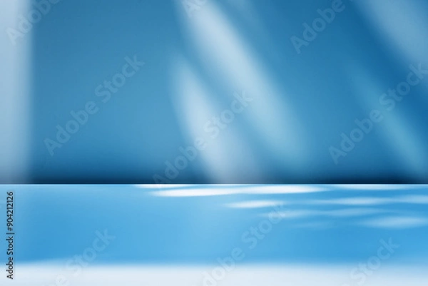 Obraz Blue background with blurred light and shadows on  wall. Winter background  for product presentation.
