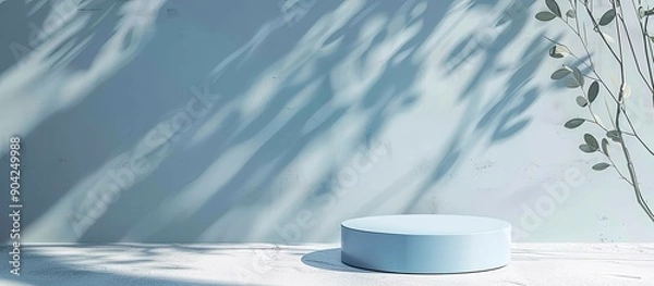 Obraz Round light blue podium under sunlight on a white table with leaf shadows in the background perfect for product presentations with copy space image