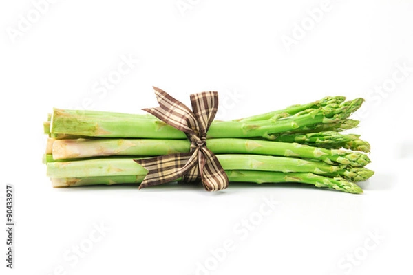 Obraz Asparagus bind with brown ribbon on white background
