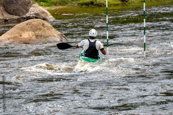 Obraz A kayaker negotiates his way through whitewater rapids. Kayaking, extreme fall. 
