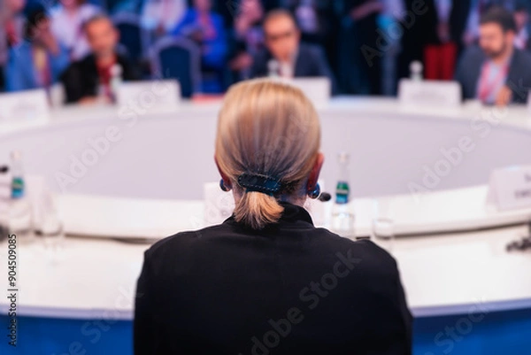 Fototapeta Group of women in business suits at round table, board meeting, roundtable talking and discussing at conference, female politicians and entrepreneurs, businesswomen dialog on forum, panel discussion