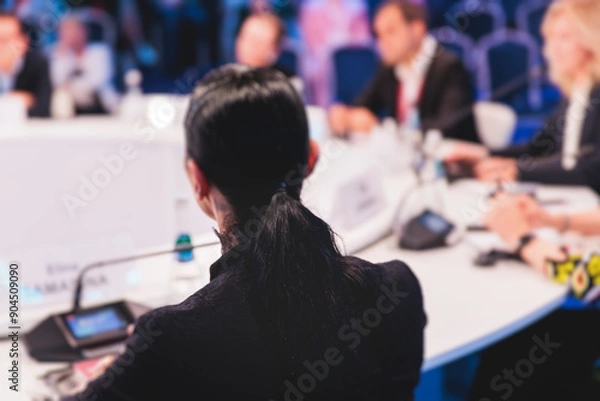 Fototapeta Group of women in business suits at round table, board meeting, roundtable talking and discussing at conference, female politicians and entrepreneurs, businesswomen dialog on forum, panel discussion