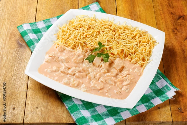 Fototapeta Homemade chicken stroganoff in ceramic plate on red checkered tablecloth