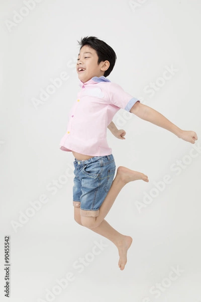 Obraz Happy asian boy is jumping at studio.