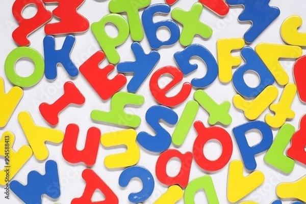 Fototapeta Alphabet. Many colorful magnetic letters on white background, flat lay