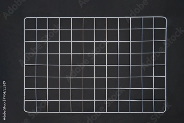 Obraz White wire grid wall on black background isolated