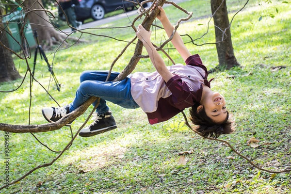 Fototapeta Little boy climb on a tree rope