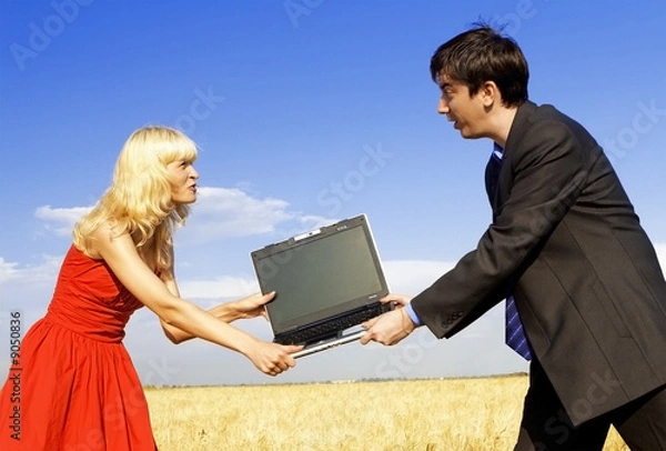 Fototapeta businessman and lady in red fighting for notebook