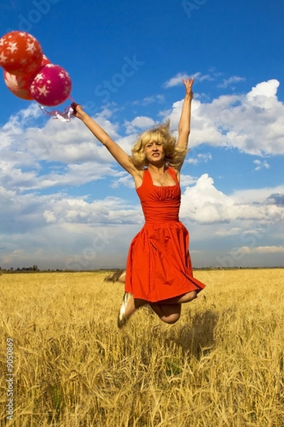 Fototapeta lady in red jumping with balloons