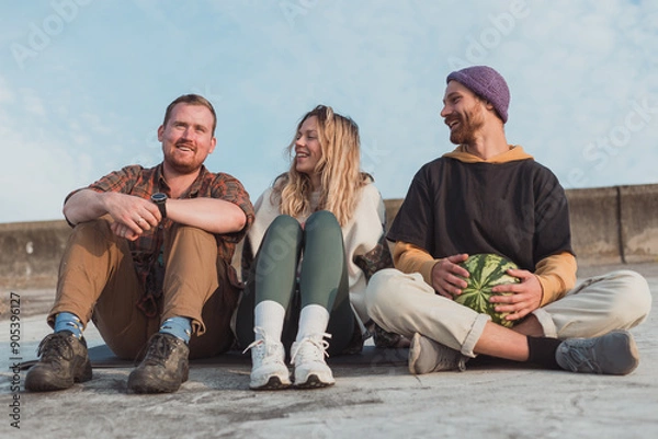 Obraz thre young friends chilling at the domntown with watermelon - photo with selective focus