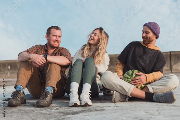 Obraz thre young friends chilling at the domntown with watermelon - photo with selective focus