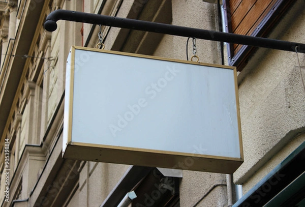 Fototapeta Street storefront shop, cafe, restaurant mounted signboard mock up design template. Blank white store sign design mockup.