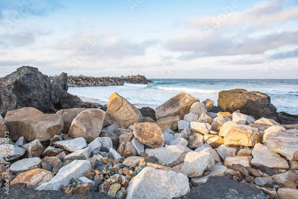 Obraz beach background for summer travel with rock beach, beautiful blue sea and  cloudy sky