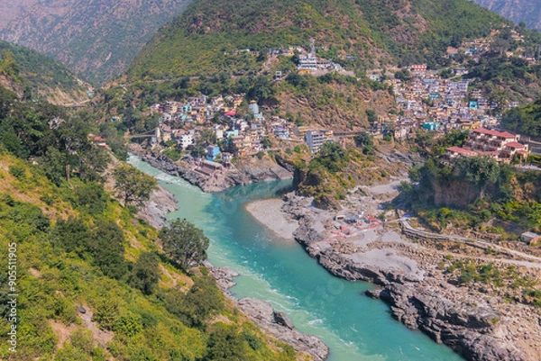 Fototapeta Bhagirathi river from left side and Alakananda river with turquoise blue colour from right side converge at Devprayag,Holy conflunece and form river Holy Ganges thereafter.Garhwal, Uttarakhand, India.