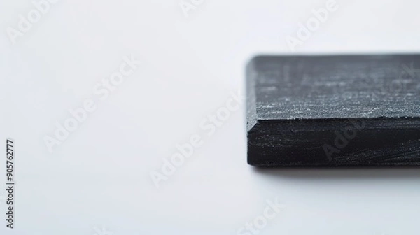 Fototapeta Close-up of Blackboard Eraser on White Background with Soft Lighting, High Contrast Educational Concept, Copy Space for Text.