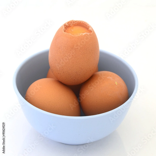 Fototapeta Egg in light blue cup on white background