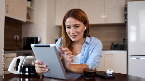 Fototapeta Beautiful woman searching the web on a tablet