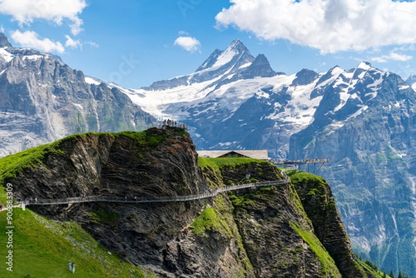 Fototapeta Grindelwald, Switzerland - View of Grindelwald First Cliff Walk, with many tourists walking the observation platform