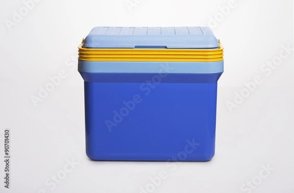 Obraz beautiful  blue cooler with a. yelllow handle on . white