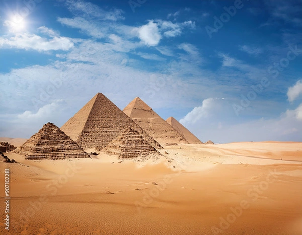 Fototapeta The great pyramids of Giza in Egypt under the vibrant blue sky with clouds