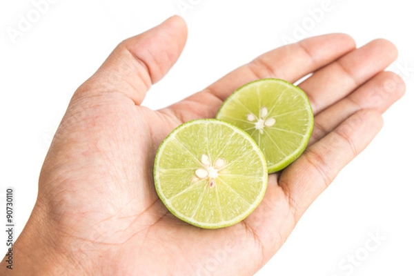 Fototapeta half lemon in man hand on white background isolated.