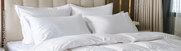 Fototapeta Cozy white bedding with plump pillows and a soft duvet, creating a serene and inviting bedroom atmosphere.