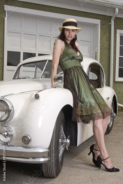 Fototapeta Beautiful woman leaning on a classic Jaguar car